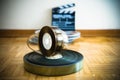 Cinema film reel and out of focus movie clapper board Royalty Free Stock Photo