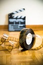 Cinema film reel and out of focus movie clapper board Royalty Free Stock Photo