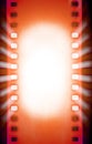 Cinema film strips with and projector light rays. Royalty Free Stock Photo