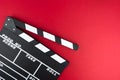 Cinema minimal concept. Watching film in the cinema. clapper board on red background. Royalty Free Stock Photo