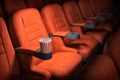 Cinema movie theater concept background. Red cinema seats and cola in empty theater