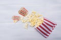 Cinema popcorn packaging and two movie tickets Royalty Free Stock Photo