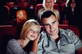 Cinema, relax and happy couple watching film or show on romantic date together in evening. Movie night, man and woman in Royalty Free Stock Photo