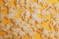 Cinema session, film, popcorn, 3D glasses. View movie concept, discounts. Background of yellow popcorn. Close-up popcorn on a