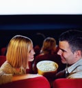 Cinema, smile and couple with popcorn, watching film or eating on romantic date together. Movie night, happy man and Royalty Free Stock Photo