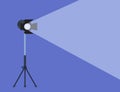 Cinema spotlight. Lamp projector on a tripod with scattered rays. Light source, studio lighting. Equipment for filming. Vector Royalty Free Stock Photo