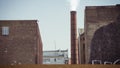 Cinemagraph of smoke emitted from an industrial brick chimney in an old factory building