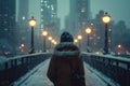 Cinematic back view of cinematic young man in winter coat walking outside in urban city on bridge on a moody, foggy, winters night Royalty Free Stock Photo