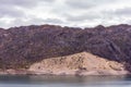 Cinematic lake surrounded by red cliffs in Provincia de Mendoza, Argentina Royalty Free Stock Photo