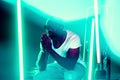 Cinematic portrait of handsome young man in neon lighted room, stylish musician