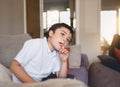 Cinematic portrait young boy biting finger and looking out with thinking face. Emotional Child deep in thought with a hand on lips Royalty Free Stock Photo