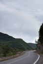 Cinematic road landscape. Asphalt Road throuth the mountains. With cloudy sky Royalty Free Stock Photo