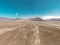 Cinematic shot aerial view of beautiful Mount Bromo volcano with desert in East Java