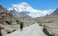 Cinematic shot of travelers hiking towards breathtaking windswept Mount Everest.