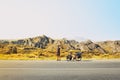 Cinematic travel inspirational panorama caucasian traveler cyclist stand on road take smiley self-portrait with mobile phone. Solo