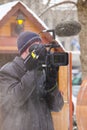 Cinematographer filming using its camera in winter time