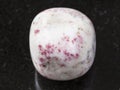 cinnabar in polished white dolomite stone on dark