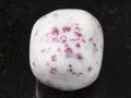 cinnabar in tumbled white dolomite stone on dark