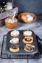 Cinnabon roll with poppy seeds on background. Homemade cinnamon bun with cream cheese cream Royalty Free Stock Photo