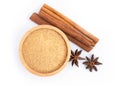 Cinnamon powder in wooden bowl and cinamon sticks with star anise isolated on white background. Royalty Free Stock Photo