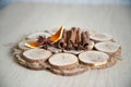 Cinnamon, anise, orange bark on wooden plate