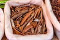 Cinnamon in the bag at Indian market close up. Small retail trade of spices in Asia