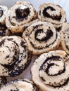 Cinnamon bun poppy seeds raisins cream glaze bakery product tasty dessert food photo