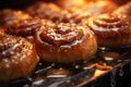 cinnamon buns on a baking sheet with caramel drippings