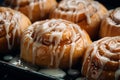 cinnamon buns with icing on top in a baking pan