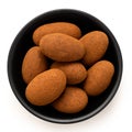 Cinnamon and chocolate coated almonds in a bowl isolated Royalty Free Stock Photo