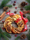 Cinnamon cocoa brown sugar wreath buns. Sweet Homemade christmas baking. Roll bread, spices, decoration on wooden background. New Royalty Free Stock Photo