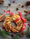 Cinnamon cocoa brown sugar wreath buns. Sweet Homemade christmas baking. Roll bread, spices, decoration on wooden background. New Royalty Free Stock Photo