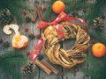 Cinnamon cocoa brown sugar wreath buns. Sweet Homemade christmas baking. Roll bread, tangerines, decoration on wooden background. Royalty Free Stock Photo