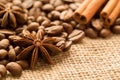 Coffee beans, anise and cinnamon on brown burlap. Close up