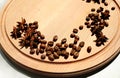 Cinnamon and coffee grainsare on a round wooden board