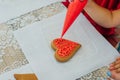 cinnamon cookies icing decorating process with a pastry bag