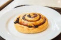 Cinnamon danish on white plate for breakfast