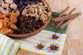 Cinnamon, dried apricot, nuts, faygi, dates and raisins in a wooden cup on a tablecloth Royalty Free Stock Photo