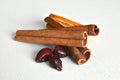 Cinnamon, dried orange and dried rose hips on a white background