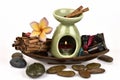Cinnamon essential oil and oil burner burned on a white background. Royalty Free Stock Photo
