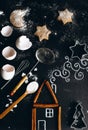 Cinnamon house on the table is complemented by a chalk pattern and utensils for making cookies Royalty Free Stock Photo