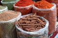 Cinnamon and other spices sold in plastic bags at bazaar Royalty Free Stock Photo