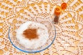 Cinnamon powder with crystal sugar in a glass bowl. Crochet tablecloth background. Top view Royalty Free Stock Photo