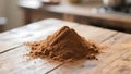 Cinnamon powder mound with a stick on a rustic wooden surface, warm tones Royalty Free Stock Photo