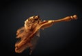 Cinnamon powder is poured out of the wooden spoon Royalty Free Stock Photo