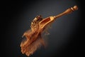 Cinnamon powder is poured out of the wooden spoon Royalty Free Stock Photo