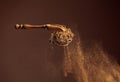 Cinnamon powder is poured out of the wooden spoon Royalty Free Stock Photo