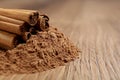 Cinnamon powder and sticks on wooden table, closeup. Space for text Royalty Free Stock Photo