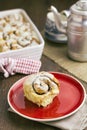 Cinnamon roll with baking dish behind Royalty Free Stock Photo