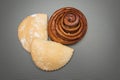Cinnamon roll studio image. Homemade cakes with cottage cheese on a gray background.